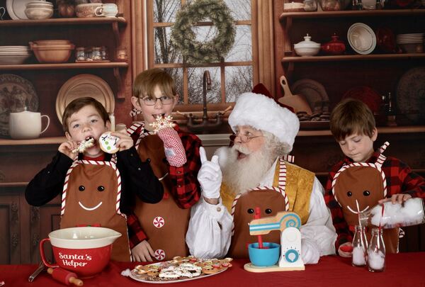 Children decorating gingerbread cookies with Santa Ray