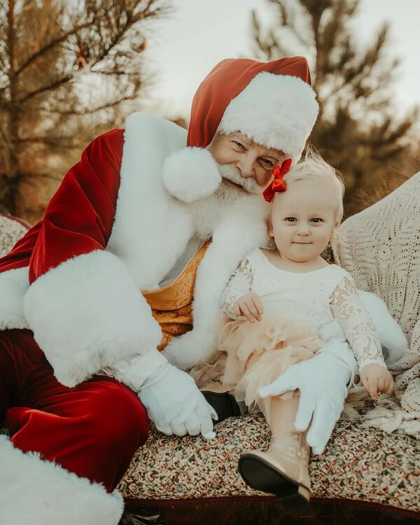 Santa Ray and a toddler in a golden outdoor setting