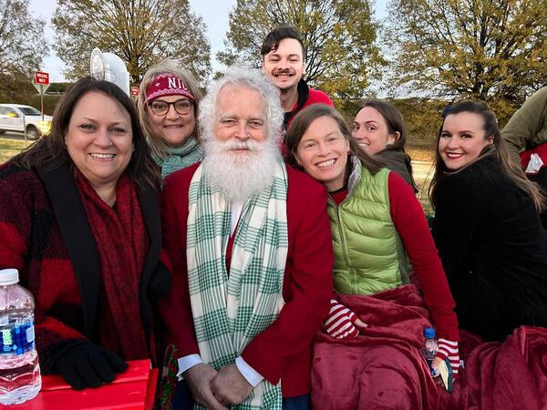 Santa Ray with a group of friends at an outdoor event
