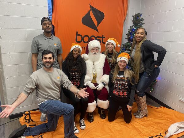 Santa Ray with a team at a company holiday party
