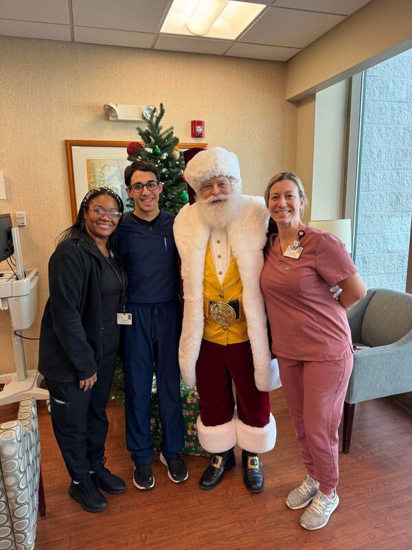 Santa Ray visiting the staff of a medical office