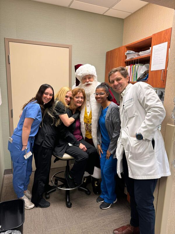 Santa Ray with doctors and nurses at a clinic