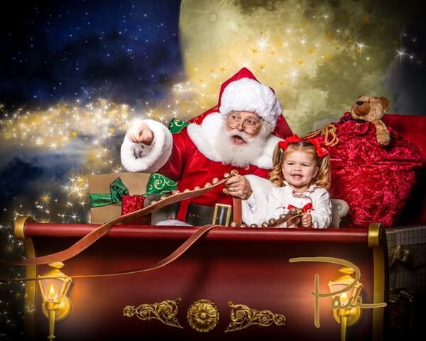 A child riding in Santa Ray’s sleigh under a starry sky