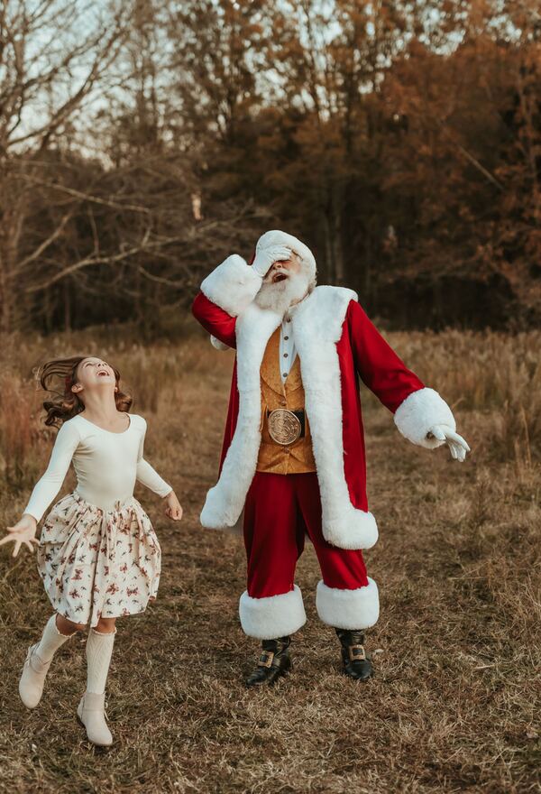 A girl dancing in a field as Santa Ray laughs