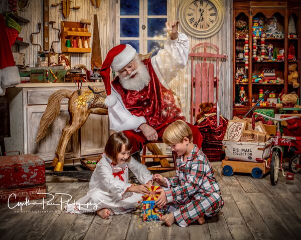 Children opening a jack-in-the-box in Santa’s workshop