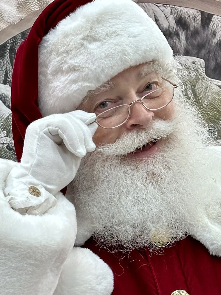 Santa Ray tipping his spectacles with a twinkle in his eye